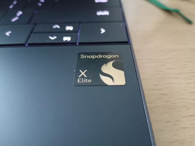 Close-up of a laptop keyboard with a gold Snapdragon X Elite sticker on the palm rest—perfect for those reading an XPS review or exploring the new Dell XPS 13 9345.